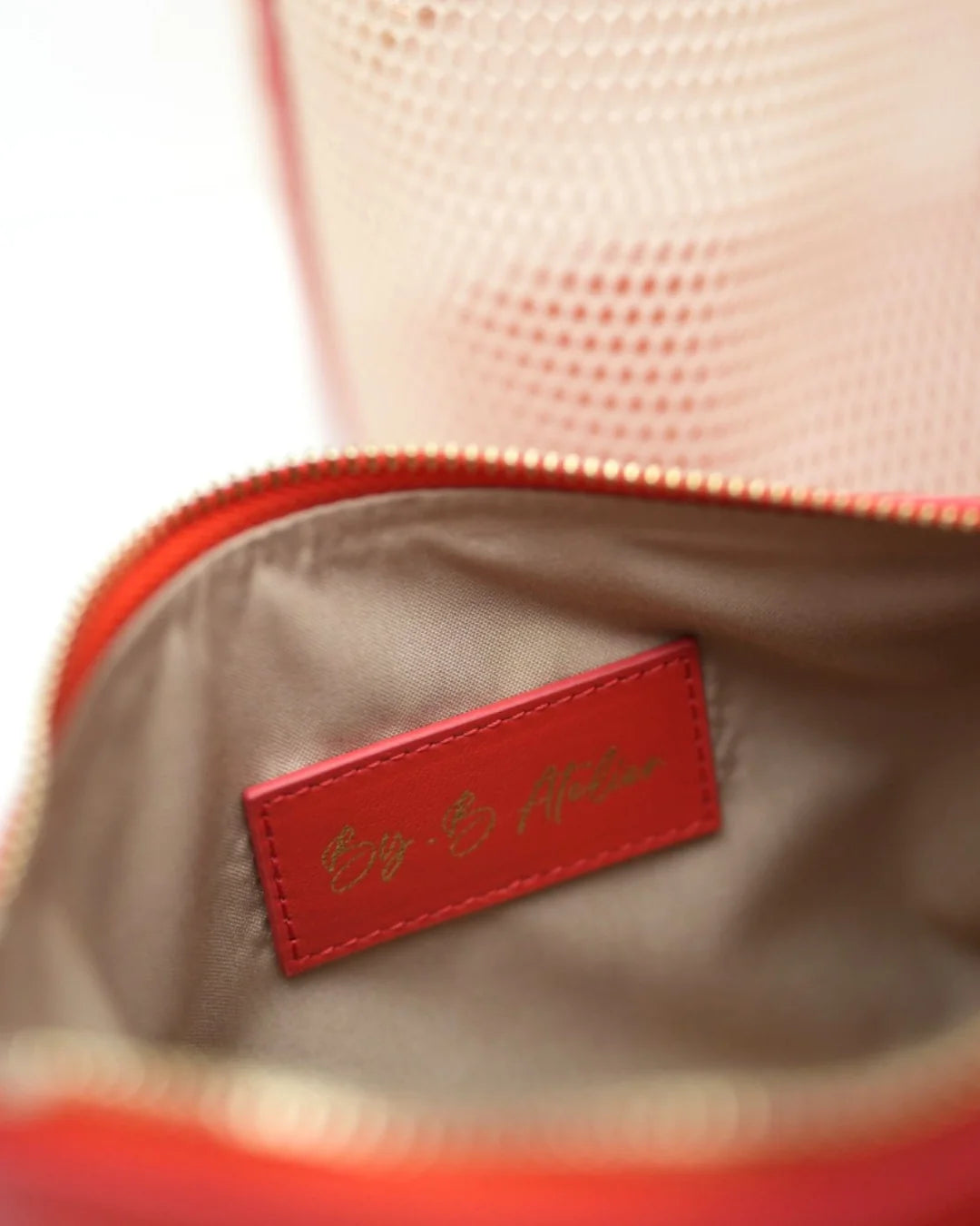 Structured designer mesh tote bag with a warm beige body and bright coral-red handles and trim | ALLBYB