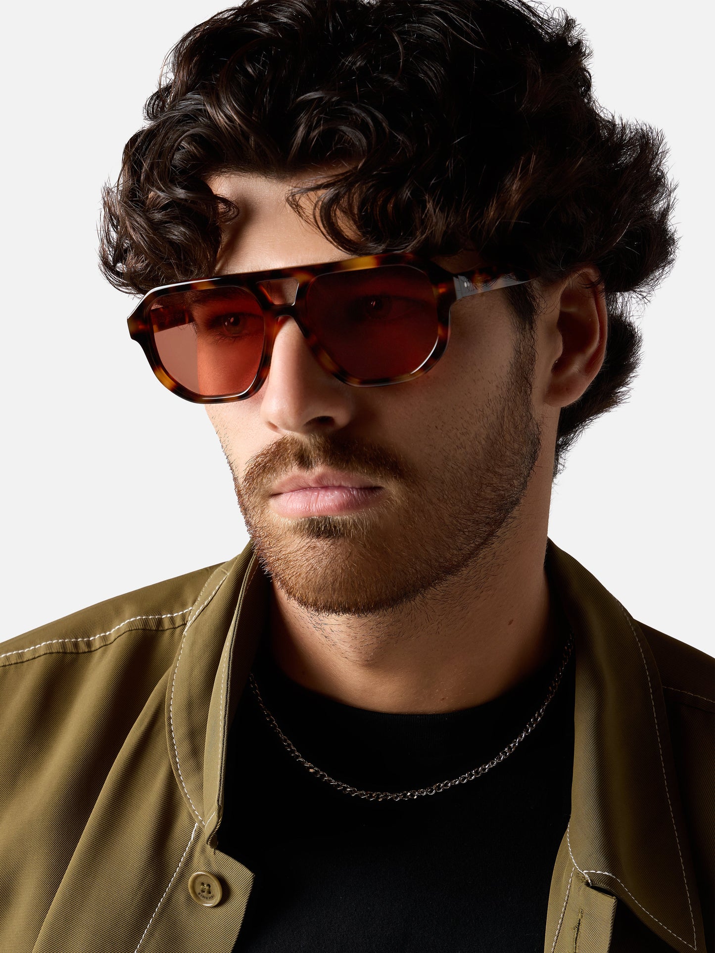 Man wearing sunglasses with a neutral background