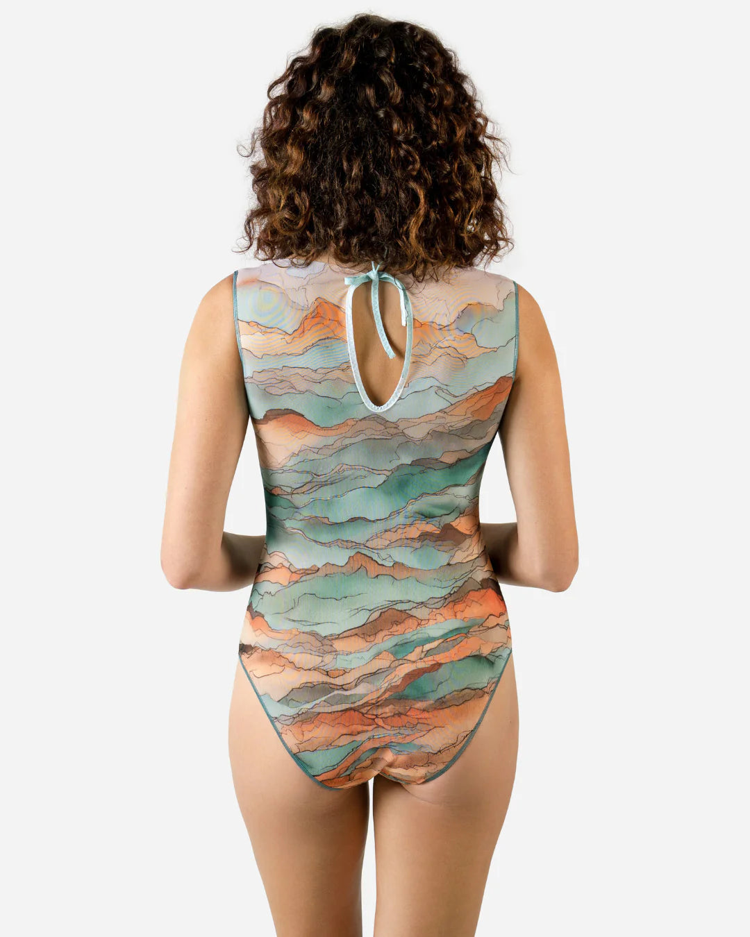 Designer sleeveless one-piece swimsuit with a watercolor-style abstract landscape print in shades of teal, peach, orange, and beige | RODA