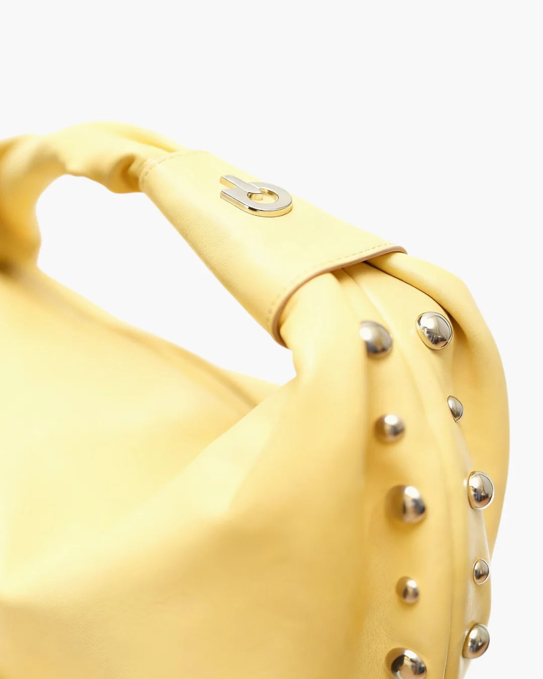 Designer bright yellow slouchy shoulder bag with a twisted top handle and silver metal studs along the edges | ALLBYB