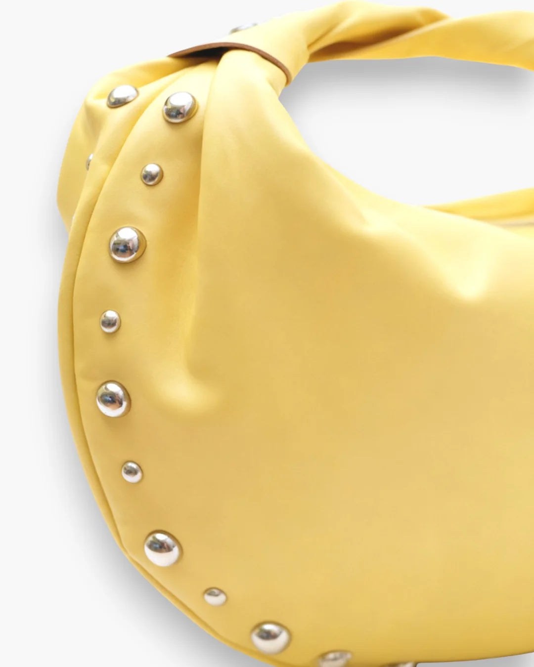 Designer bright yellow slouchy shoulder bag with a twisted top handle and silver metal studs along the edges | ALLBYB