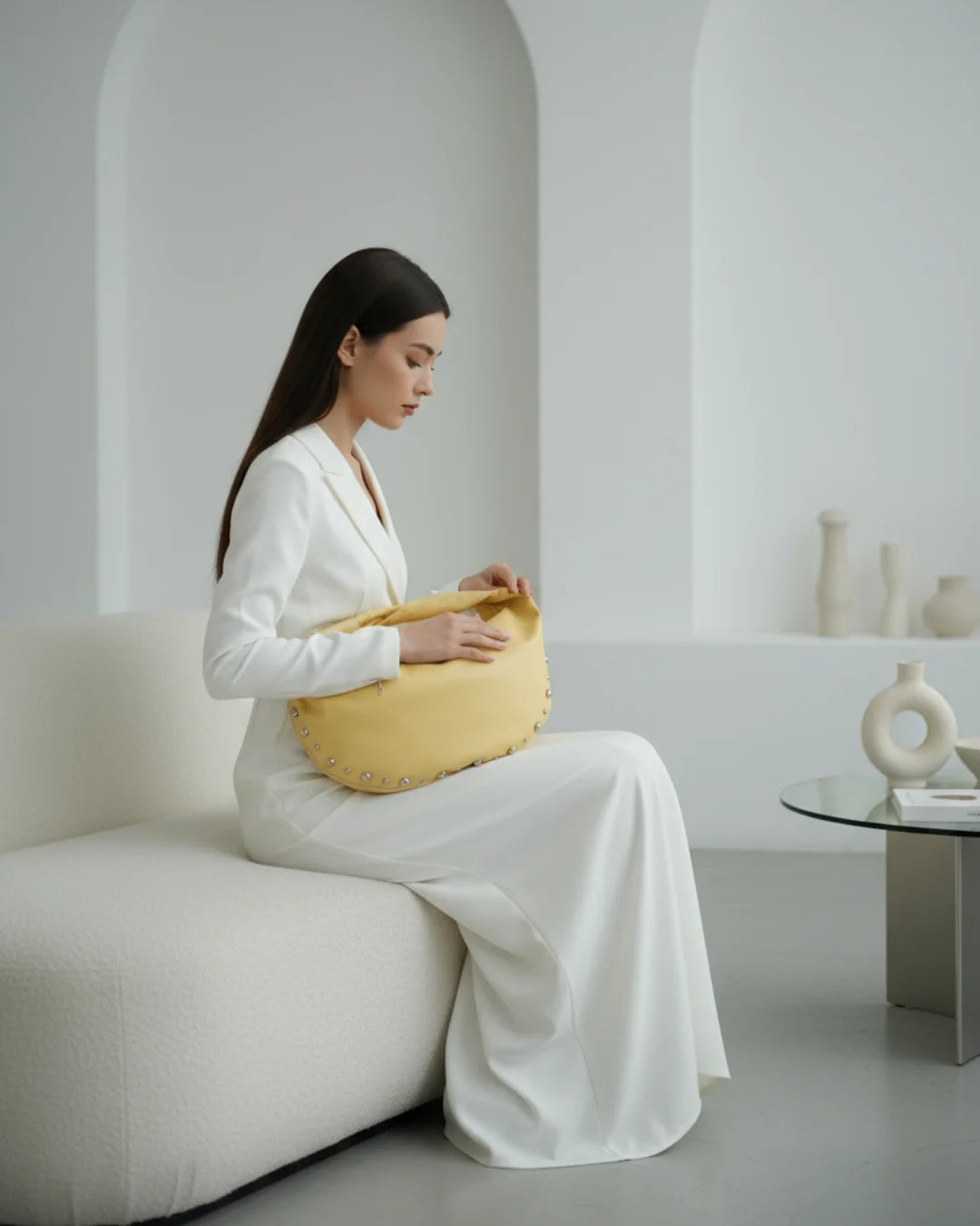 Designer bright yellow slouchy shoulder bag with a twisted top handle and silver metal studs along the edges | ALLBYB