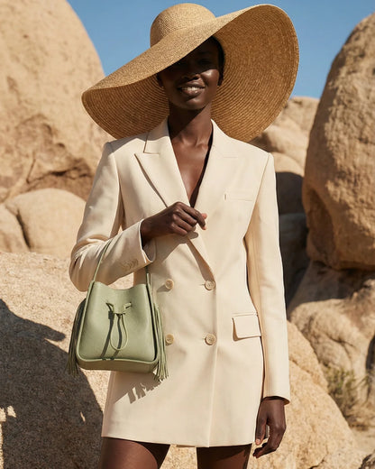 Designer olive green leather bucket bag with a top handle and drawstring closure | ALLBYB