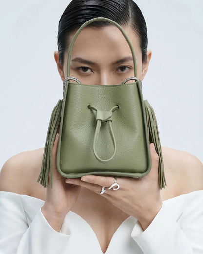 Designer olive green leather bucket bag with a top handle and drawstring closure | ALLBYB