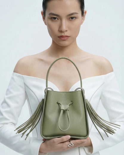 Designer olive green leather bucket bag with a top handle and drawstring closure | ALLBYB
