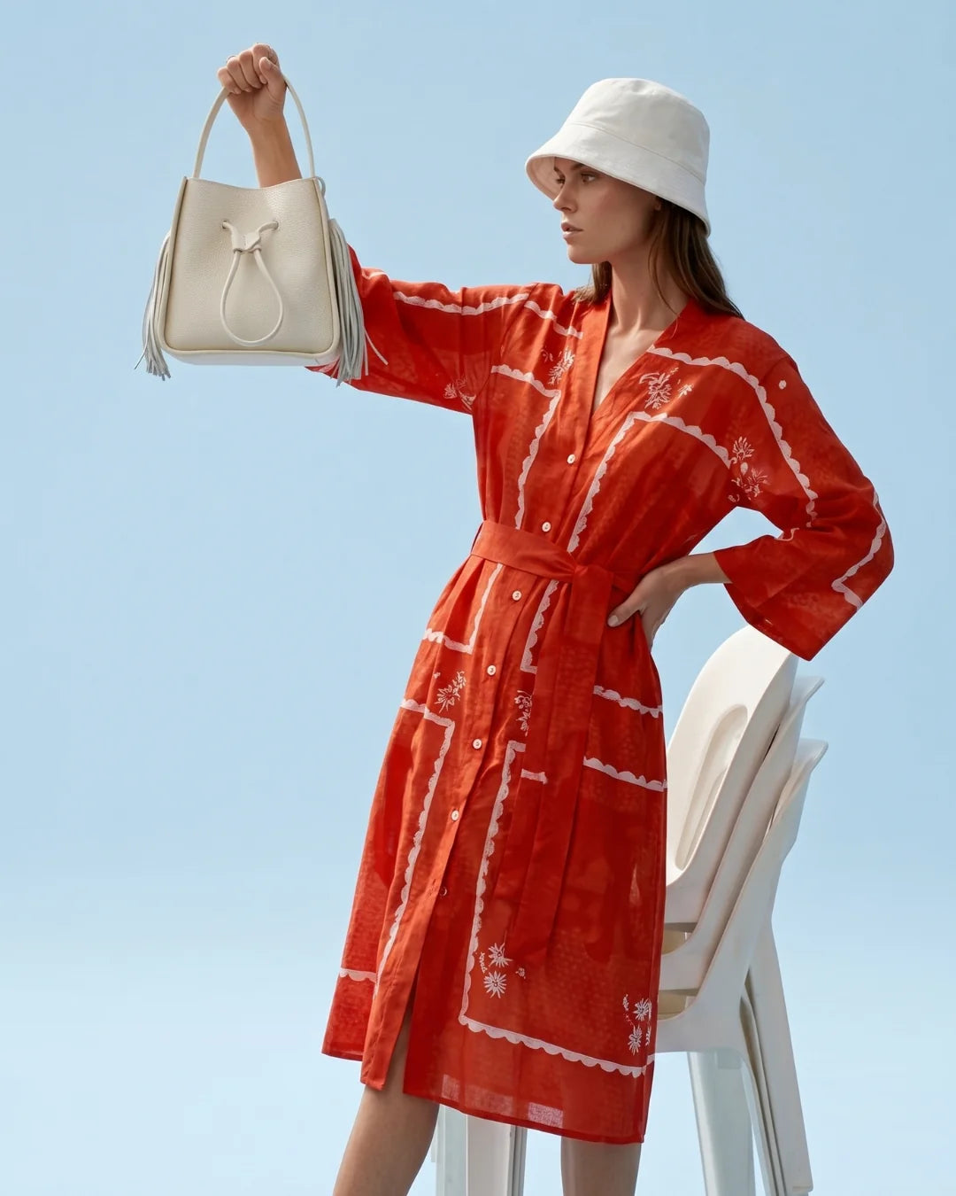 Designer beige leather bucket bag with a top handle and drawstring closure | ALLBYB