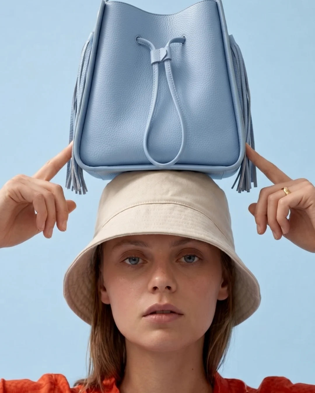 Designer light blue leather bucket bag with a top handle and drawstring closure | ALLBYB