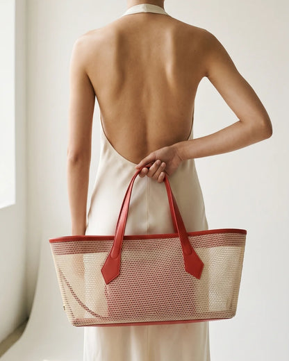 Structured designer mesh tote bag with a warm beige body and bright coral-red handles and trim | ALLBYB