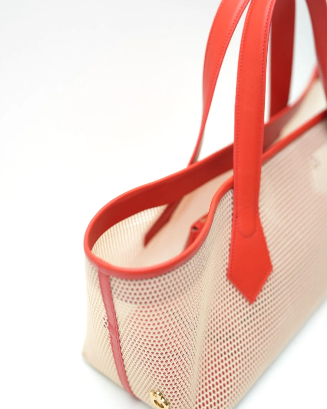 Structured designer mesh tote bag with a warm beige body and bright coral-red handles and trim | ALLBYB