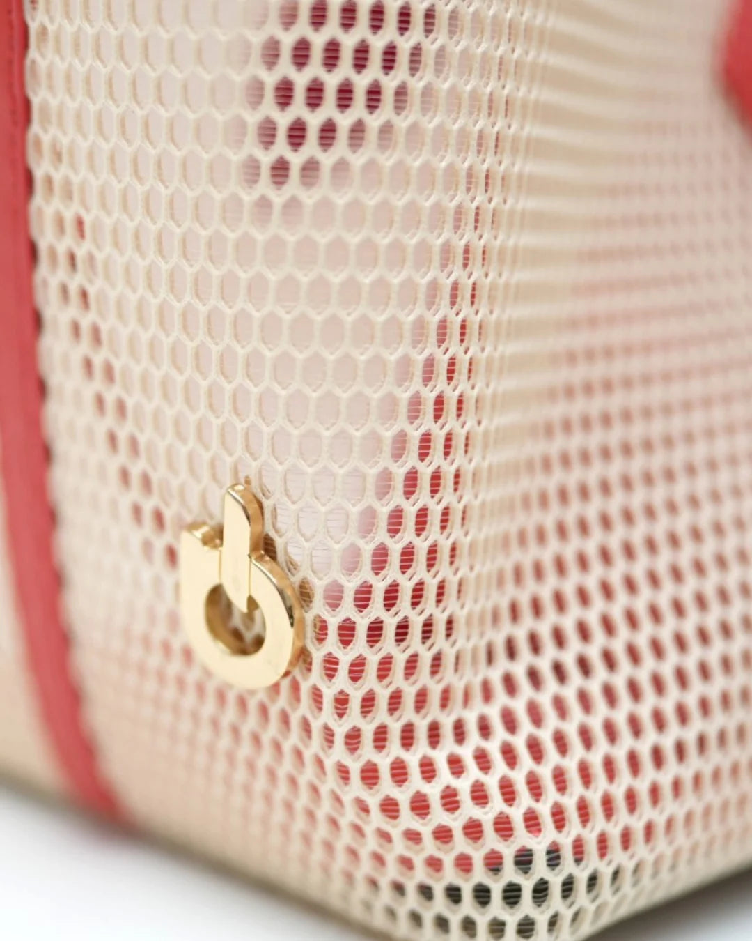 Structured designer mesh tote bag with a warm beige body and bright coral-red handles and trim | ALLBYB