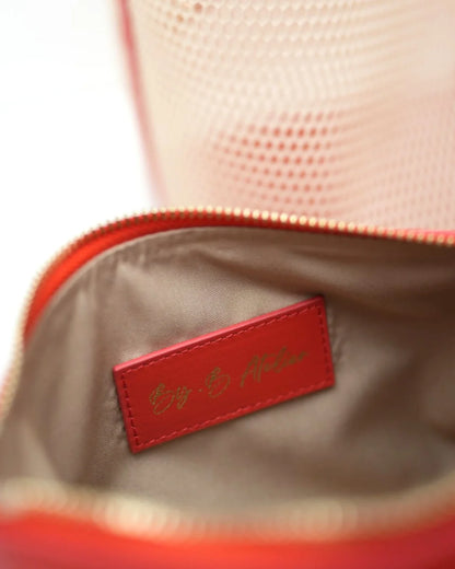 Structured designer mesh tote bag with a warm beige body and bright coral-red handles and trim | ALLBYB