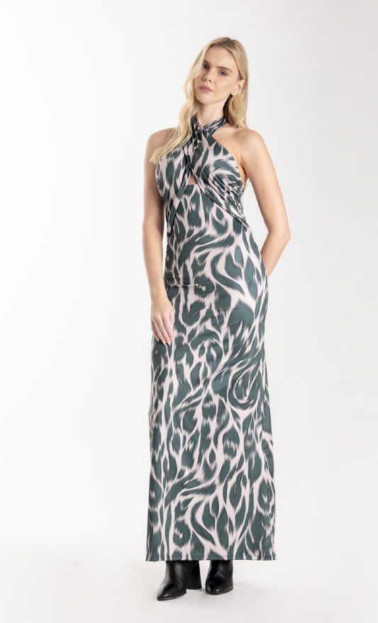 Woman wearing a patterned halter neck dress on a white background