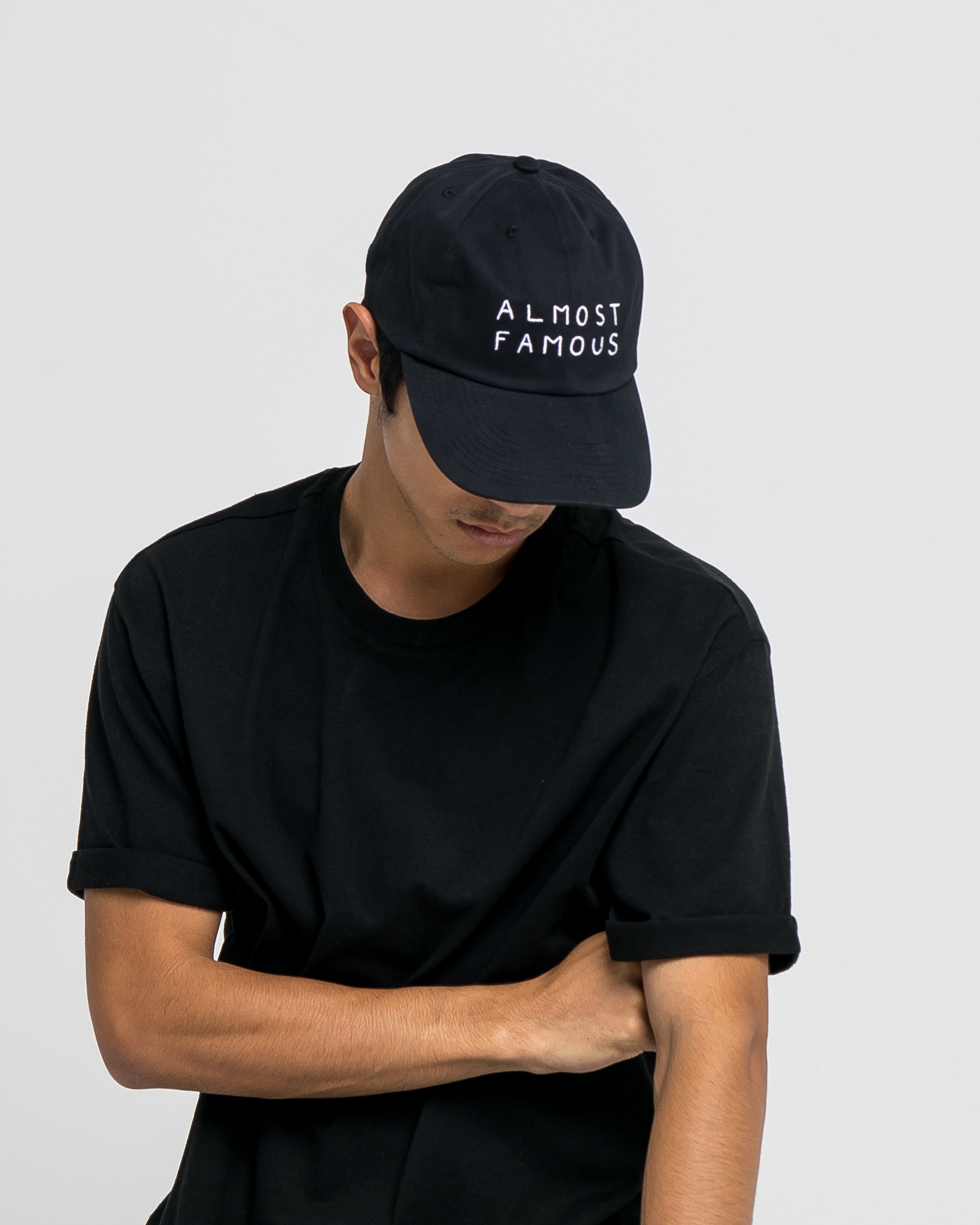 Black unisex baseball hat with white embroidery "Almost famous" from French designer brand Nasaseasons