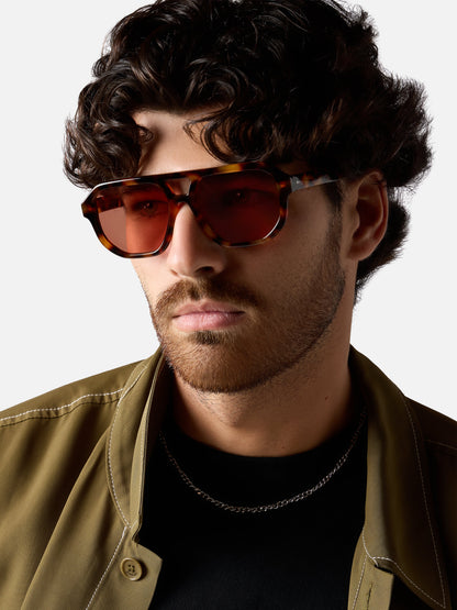 Man wearing sunglasses with a neutral background