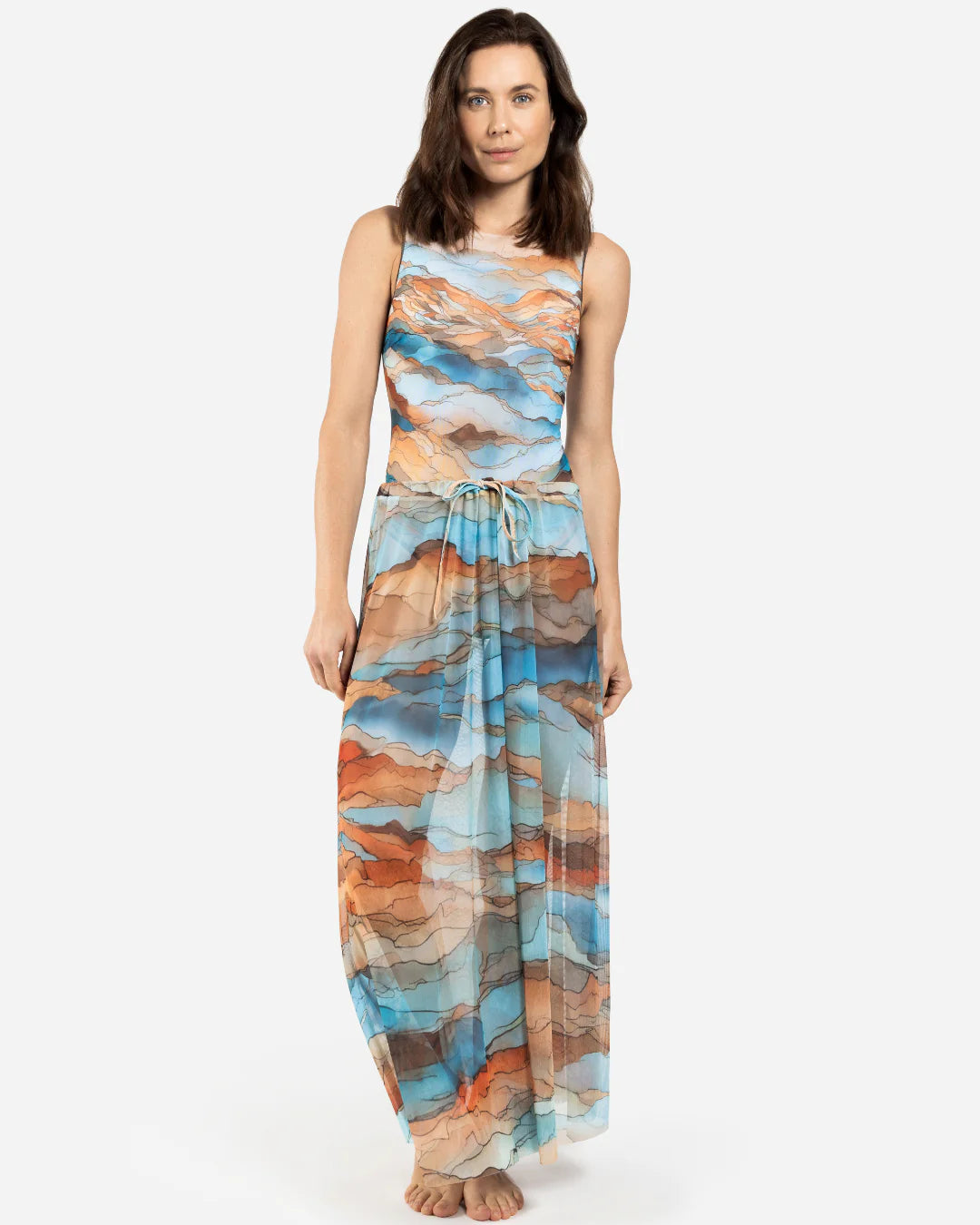 Designer maxi sheer beach skirt with a scenic abstract print of blue, orange, and beige mountains | RODA