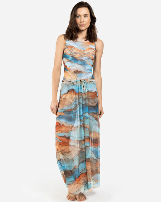 Designer maxi sheer beach skirt with a scenic abstract print of blue, orange, and beige mountains | RODA