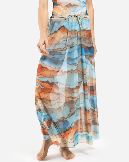 Designer maxi sheer beach skirt with a scenic abstract print of blue, orange, and beige mountains | RODA
