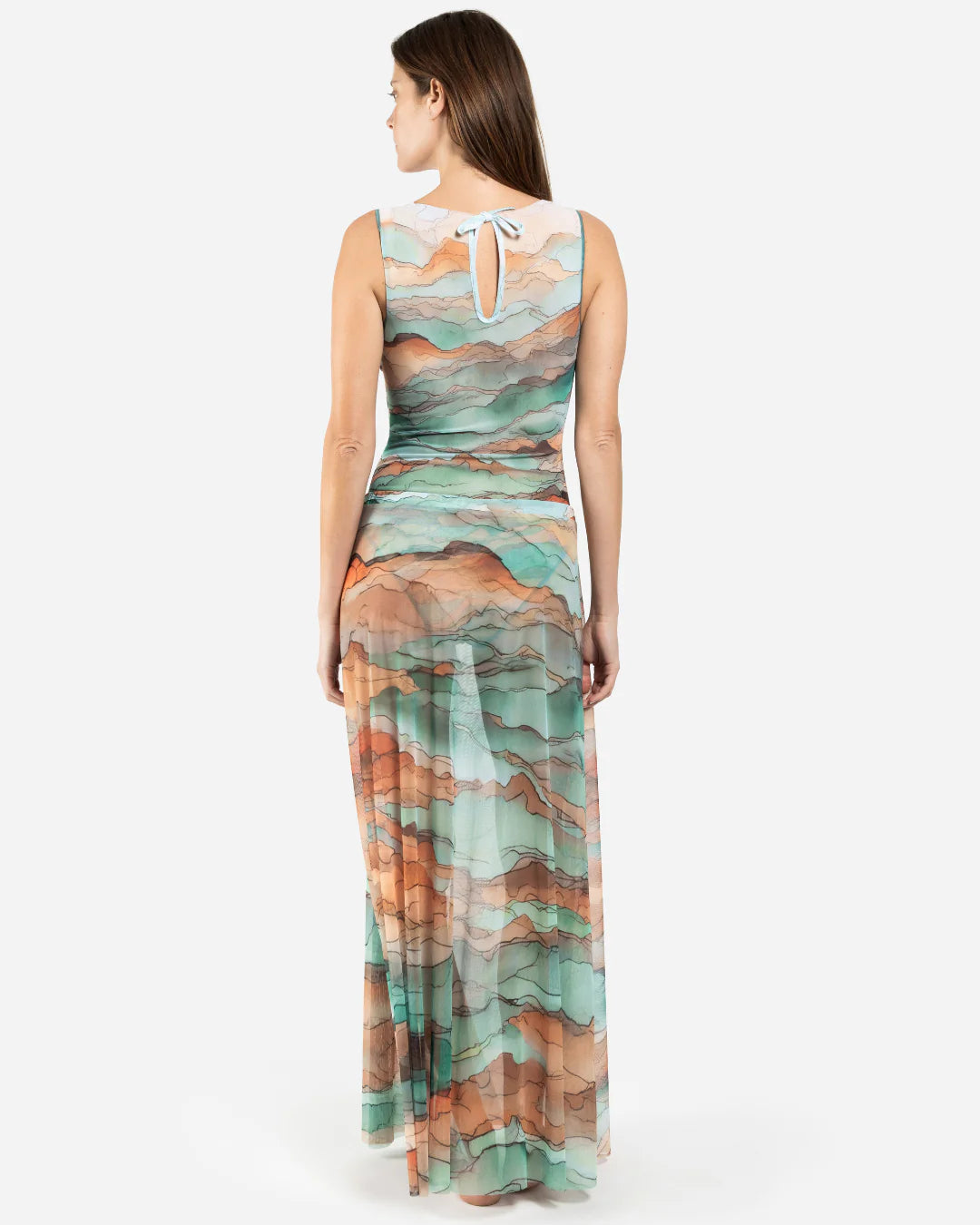 Designer maxi sheer beach skirt with a watercolor-style abstract landscape print in shades of teal, peach, orange, and beige | RODA