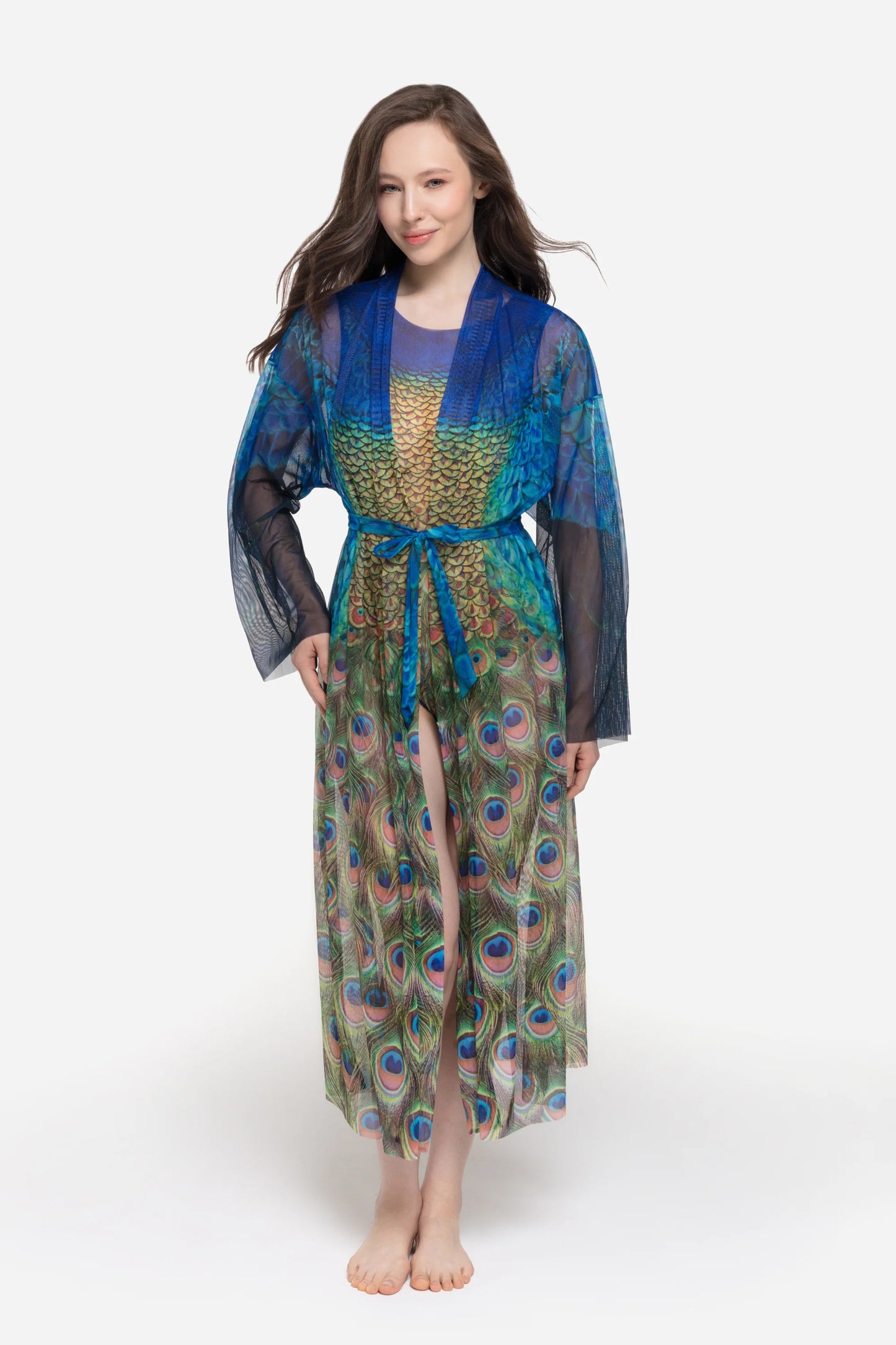 Designer long-sleeved sheer maxi beach robe with a vibrant peacock feather print, featuring a blue gradient top and a green patterned bottom | RODA