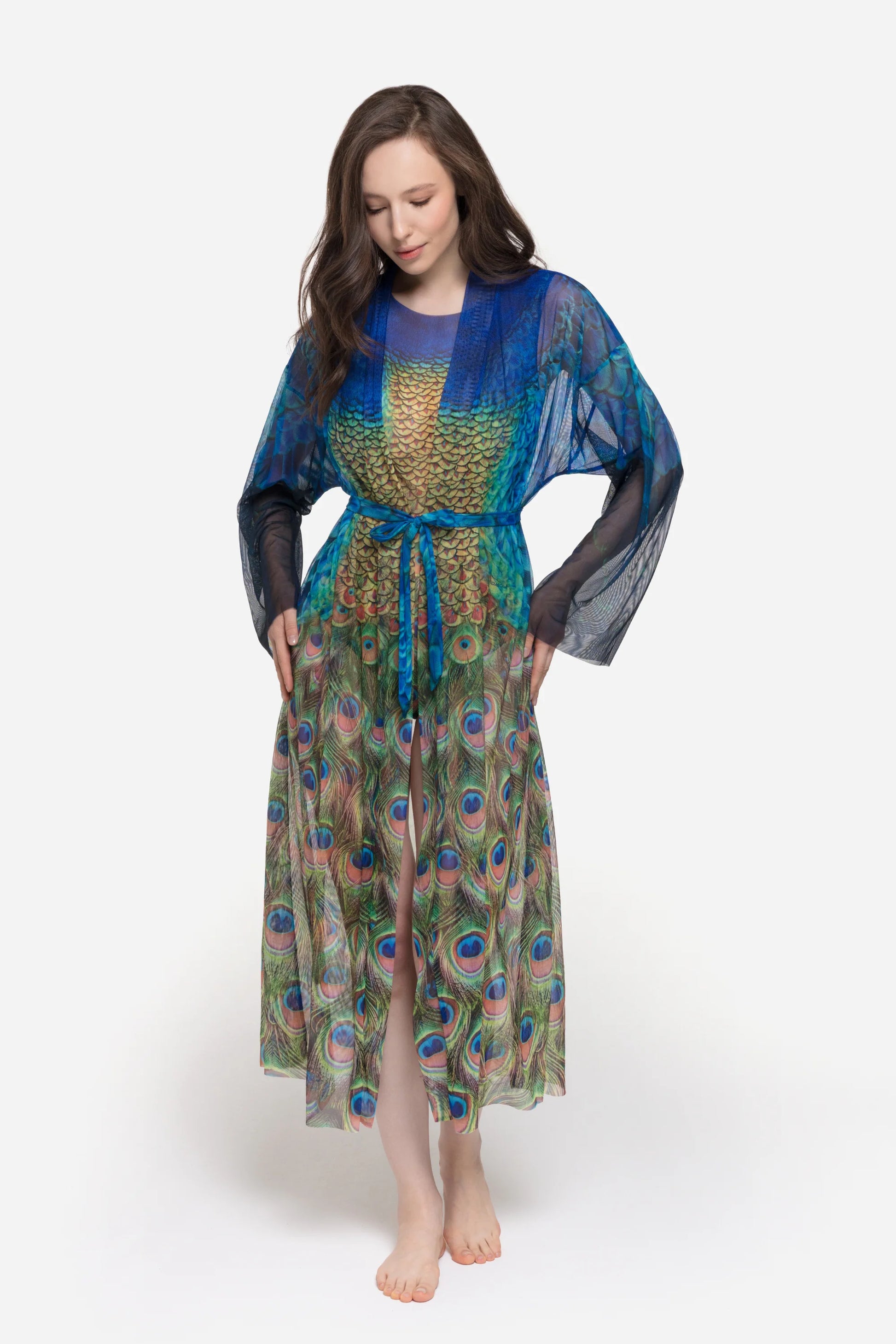 Designer long-sleeved sheer maxi beach robe with a vibrant peacock feather print, featuring a blue gradient top and a green patterned bottom | RODA
