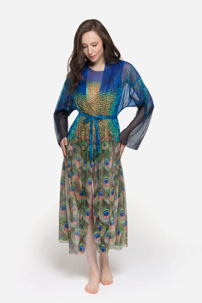 Designer long-sleeved sheer maxi beach robe with a vibrant peacock feather print, featuring a blue gradient top and a green patterned bottom | RODA