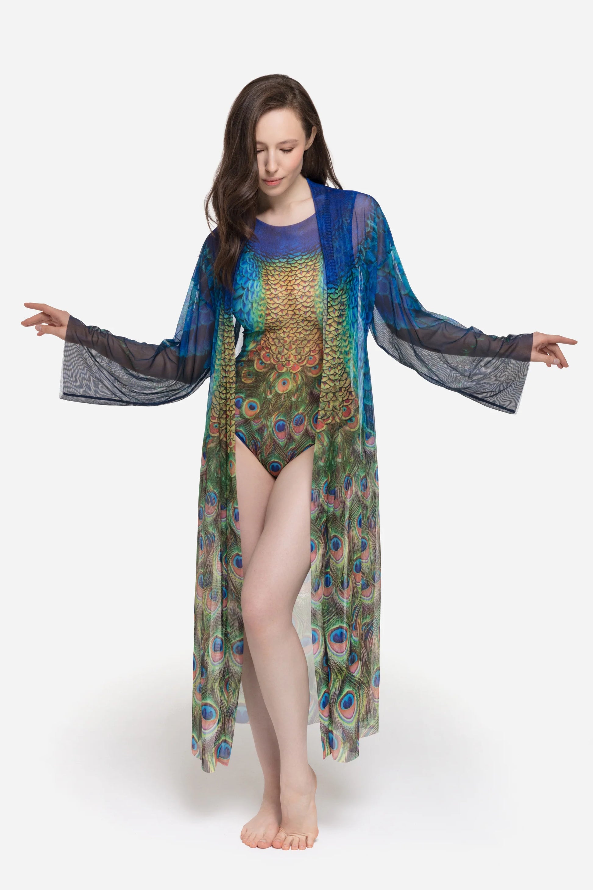 Designer long-sleeved sheer maxi beach robe with a vibrant peacock feather print, featuring a blue gradient top and a green patterned bottom | RODA