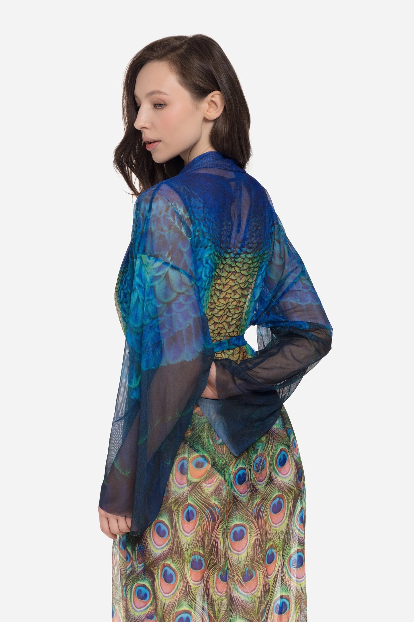 Designer long-sleeved sheer maxi beach robe with a vibrant peacock feather print, featuring a blue gradient top and a green patterned bottom | RODA