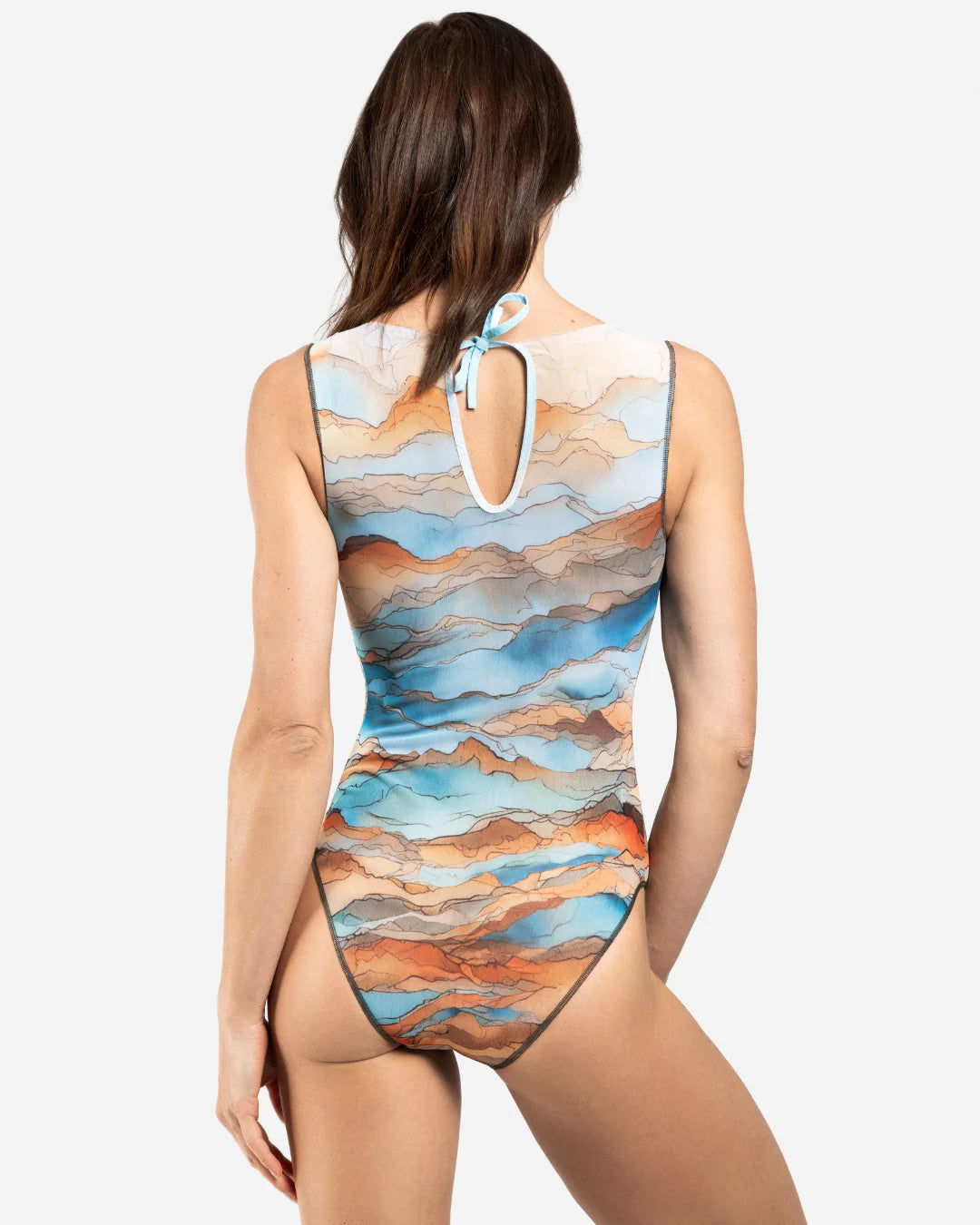 Designer sleeveless one-piece swimsuit with a scenic abstract print of blue, orange, and beige mountains | RODA