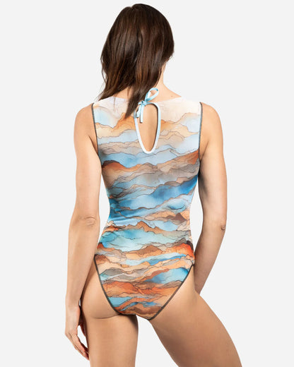 Designer sleeveless one-piece swimsuit with a scenic abstract print of blue, orange, and beige mountains | RODA