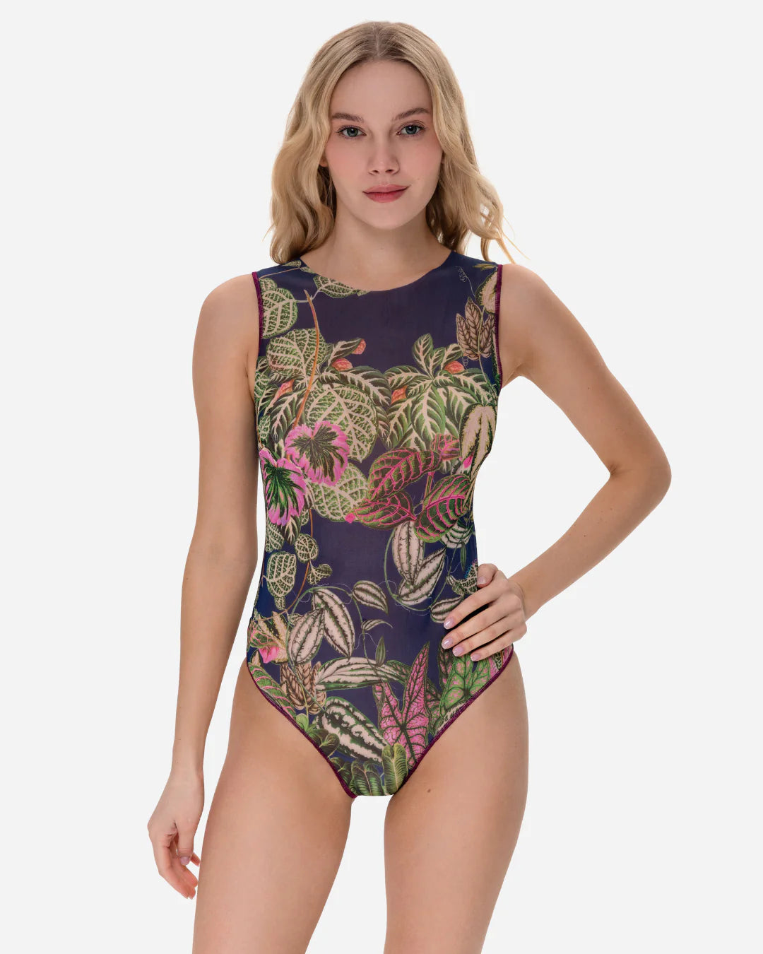 Designer sleeveless one-piece swimsuit with a detailed tropical leaf print on a dark navy blue background | RODA