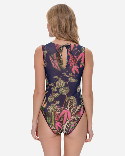 Designer sleeveless one-piece swimsuit with a detailed tropical leaf print on a dark navy blue background | RODA