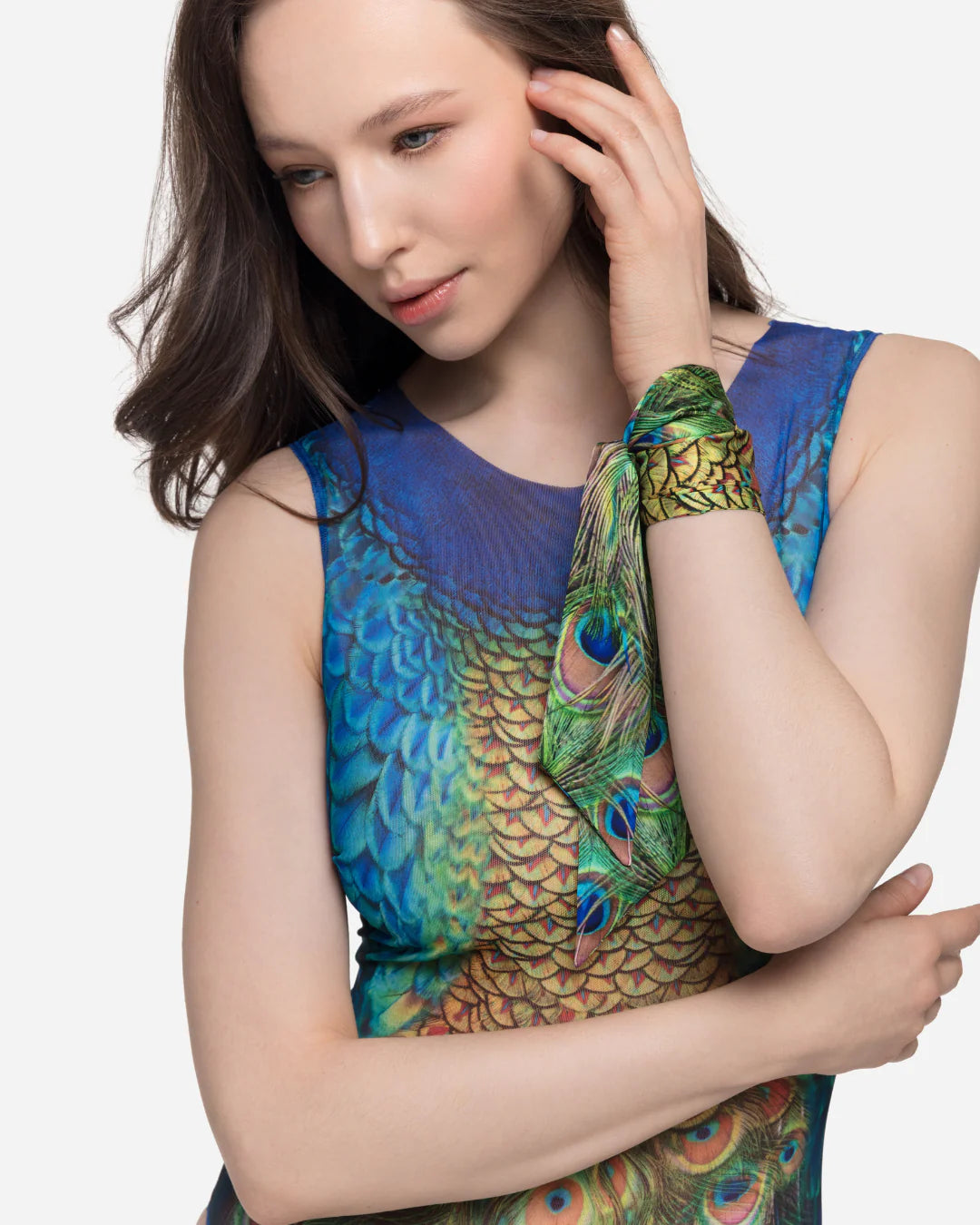 Designer sleeveless one-piece swimsuit with a vibrant peacock-inspired print with blue, green, gold, and orange tones | RODA