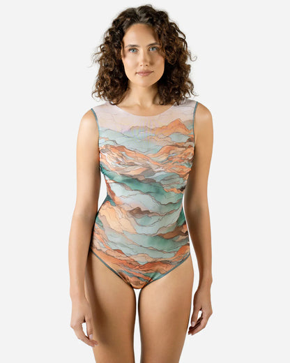 Designer sleeveless one-piece swimsuit with a watercolor-style abstract landscape print in shades of teal, peach, orange, and beige | RODA