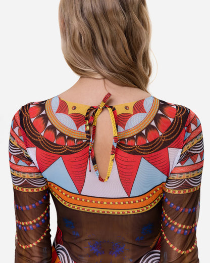 Designer long-sleeve one-piece swimsuit with a sheer mesh base and an intricate, colorful tribal-inspired geometric print featuring orange, red, yellow, black, and white patterns | RODA