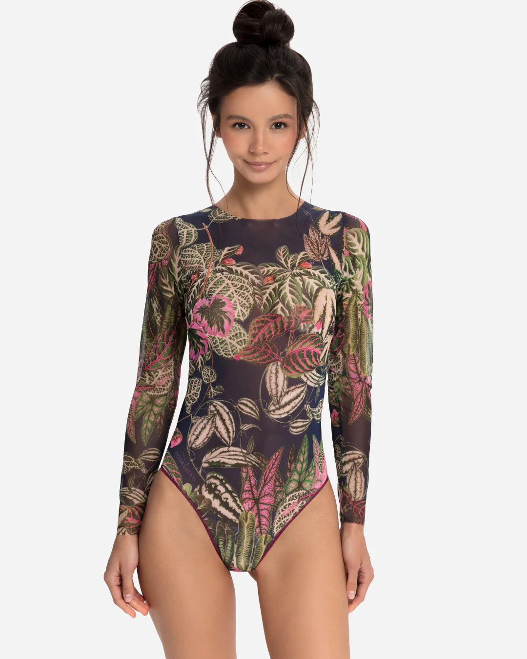 Designer long-sleeve one-piece swimsuit with a botanical jungle print on a sheer mesh fabric, featuring a dusty blue-gray base color with green, pink, and beige leaves | RODA