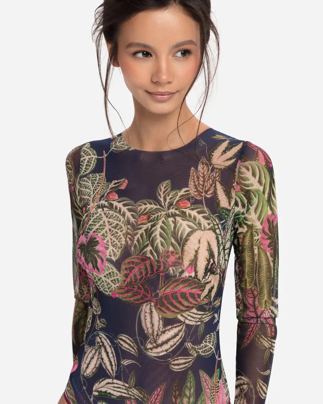 Designer long-sleeve one-piece swimsuit with a botanical jungle print on a sheer mesh fabric, featuring a dusty blue-gray base color with green, pink, and beige leaves | RODA