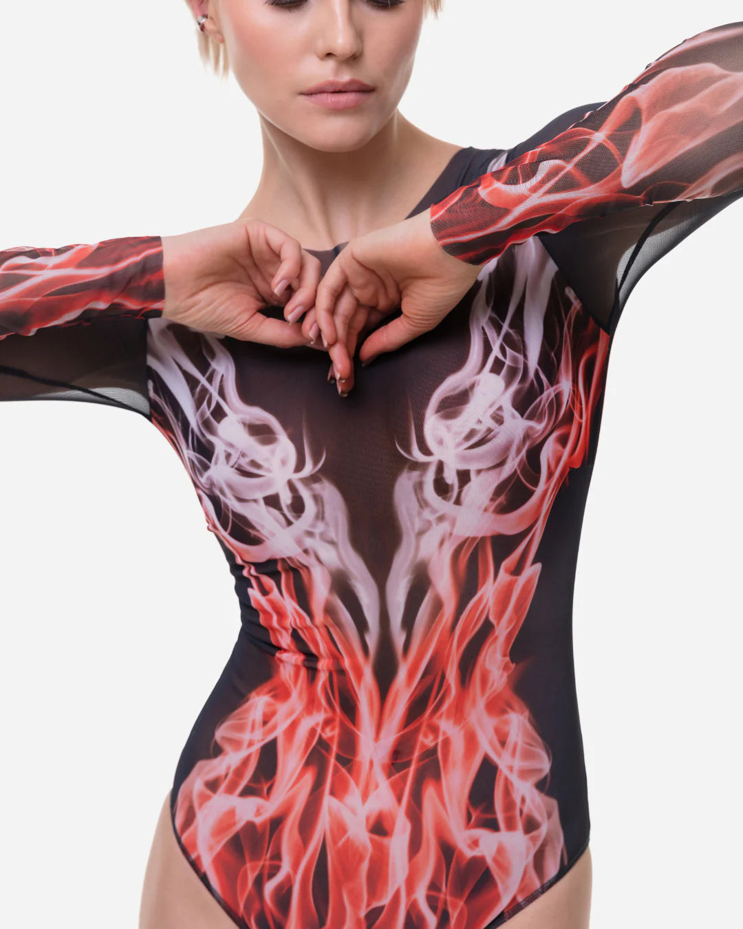 Designer long-sleeve one-piece swimsuit with a sheer black mesh upper body and sleeves, transitioning into a red, orange, and white flame-like graphic print on the lower torso and sleeves | RODA