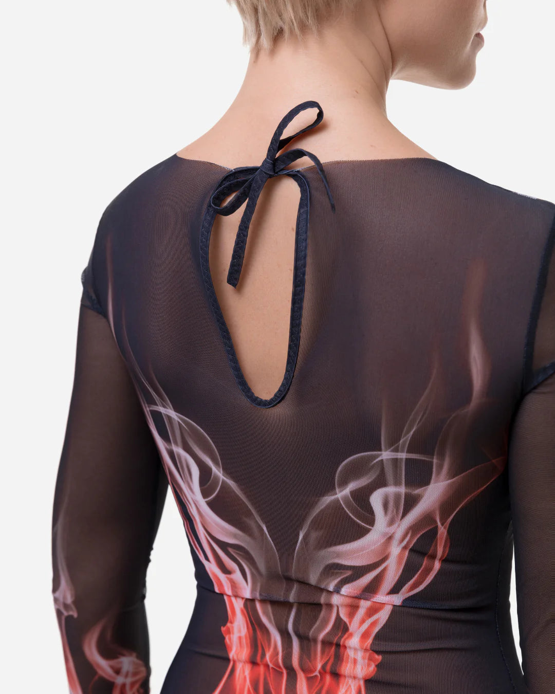 Designer long-sleeve one-piece swimsuit with a sheer black mesh upper body and sleeves, transitioning into a red, orange, and white flame-like graphic print on the lower torso and sleeves | RODA