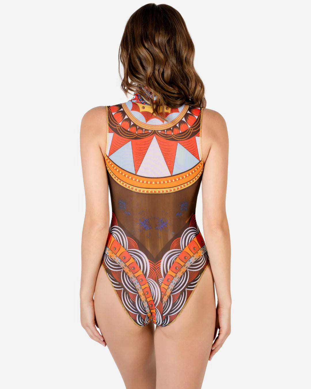 Designer sleeveless one-piece swimsuit with a high mock neck, sheer mesh panels, and a bold geometric tribal pattern in orange, red, yellow, black, and white | RODA
