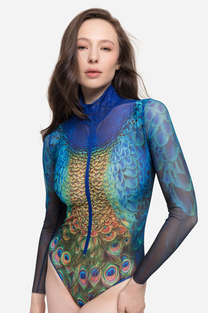 Designer long-sleeve swimsuit with a high collar and a front zipper, featuring a vibrant peacock feather and gold scale pattern in shades of blue, green, yellow, and orange | RODA